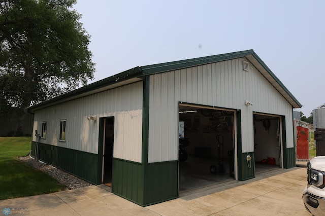 view of property exterior featuring an outdoor structure and a garage