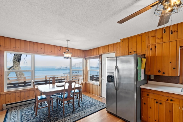 12742 Lake Miltona Dr NE, Miltona, MN 56354 - dining space featuring plenty of natural light, ceiling fan, light wood-style floors, a textured ceiling, and a water view