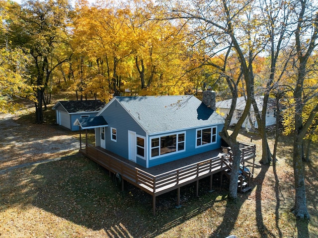 12742 Lake Miltona Dr NE, Miltona, MN 56354 - back of house featuring roof with shingles, a chimney, and a wooden deck