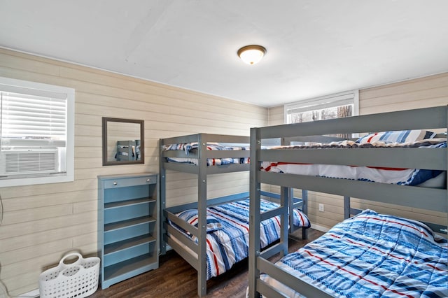 12742 Lake Miltona Dr NE, Miltona, MN 56354 - bedroom with wooden walls, dark wood-type flooring, and cooling unit