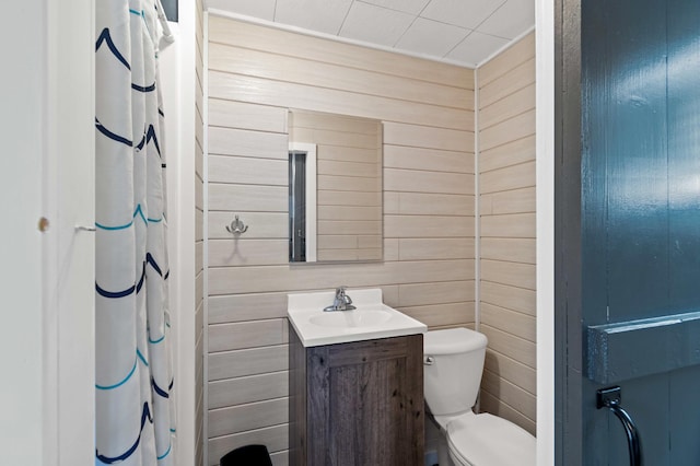 12742 Lake Miltona Dr NE, Miltona, MN 56354 - bathroom featuring wood walls, toilet, vanity, and a shower with shower curtain
