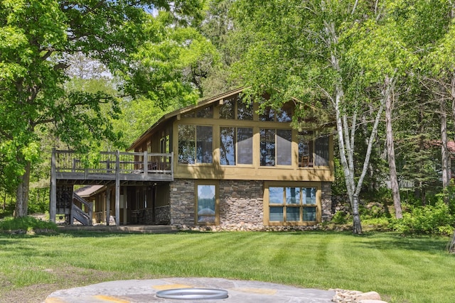 12037 Northgate Ln, Crosslake, MN 56442 - back of property featuring stone siding, a wooden deck, and a yard