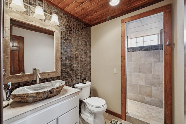 12037 Northgate Ln, Crosslake, MN 56442 - bathroom featuring wooden ceiling, toilet, tile walls, vanity, and a tile shower