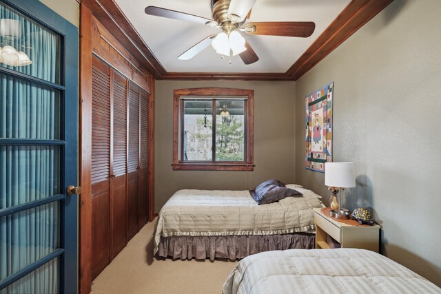 12037 Northgate Ln, Crosslake, MN 56442 - bedroom with a closet, carpet, a ceiling fan, and ornamental molding
