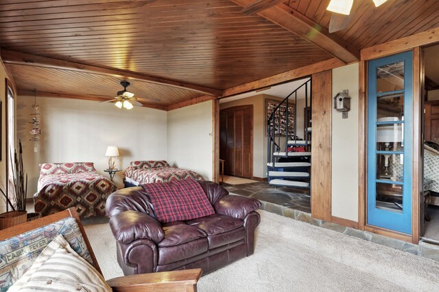 12037 Northgate Ln, Crosslake, MN 56442 - carpeted living room with stairs, wood ceiling, beamed ceiling, ceiling fan, and a skylight