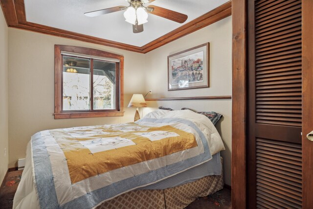12037 Northgate Ln, Crosslake, MN 56442 - bedroom featuring a closet, crown molding, carpet flooring, baseboards, and a baseboard heating unit