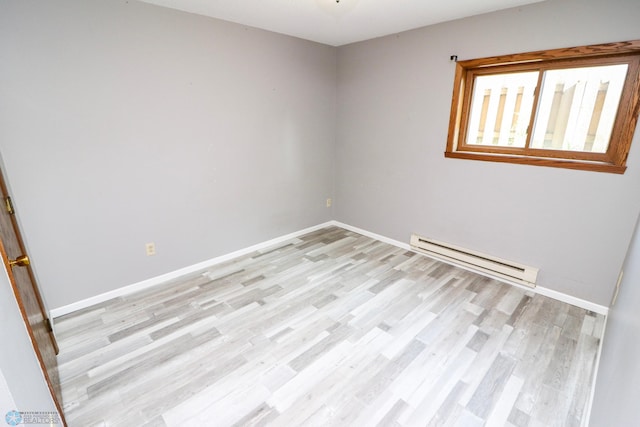 1219 7th St S Unit 1, Moorhead, MN 56560 - spare room featuring baseboard heating, light wood-style flooring, and baseboards