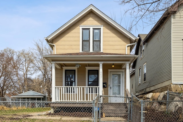 view of front of property with covered porch, a gate, and a fenced front yard