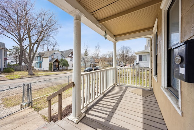 wooden terrace with a porch and a residential view