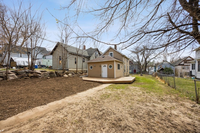 back of house featuring a residential view, fence, and a deck