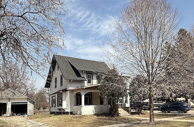 616 5th St, Madison, MN 56256 - view of front of house with a porch, an outbuilding, roof with shingles, and stucco siding