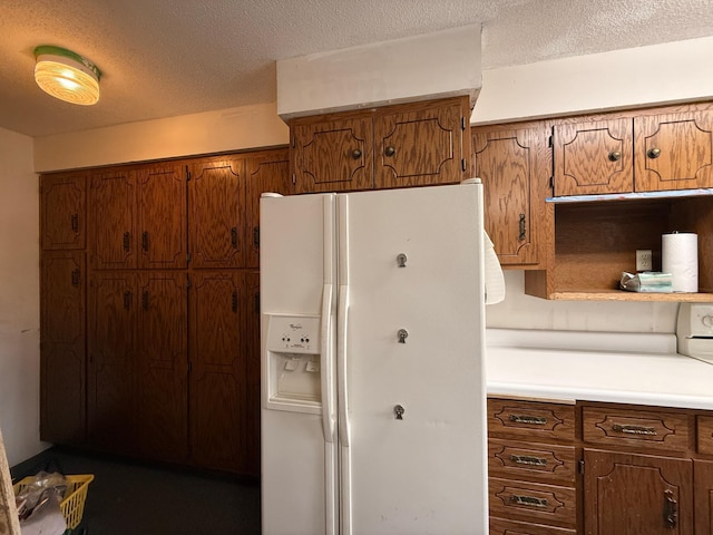 616 5th St, Madison, MN 56256 - kitchen featuring light countertops, a textured ceiling, brown cabinets, and white fridge with ice dispenser