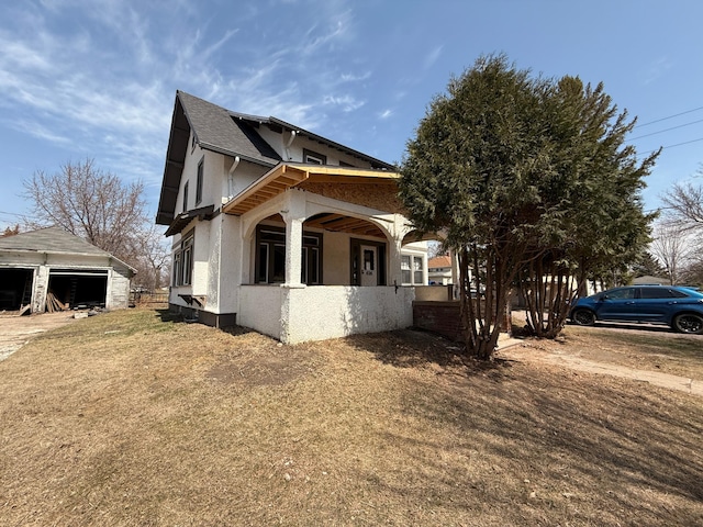 616 5th St, Madison, MN 56256 - view of home's exterior with stucco siding and an outbuilding