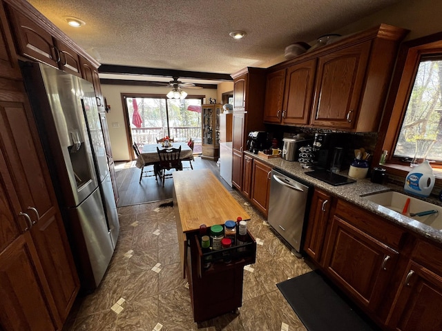 22612 Greenwood Loop, Park Rapids, MN 56470 - kitchen with stainless steel appliances, plenty of natural light, a sink, a textured ceiling, and a ceiling fan