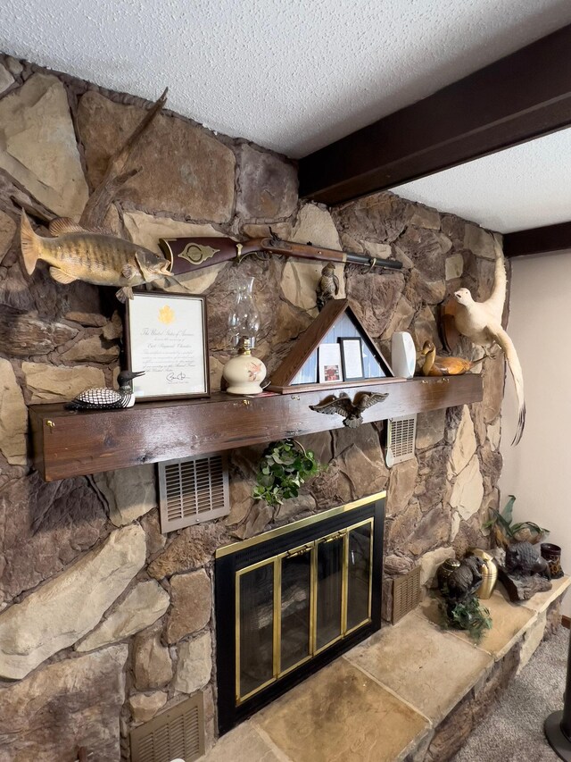 22612 Greenwood Loop, Park Rapids, MN 56470 - detailed view of a stone fireplace, a textured ceiling, and beamed ceiling