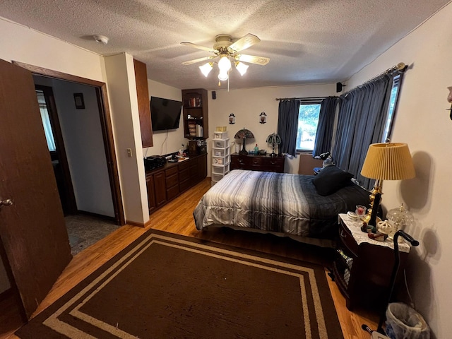 22612 Greenwood Loop, Park Rapids, MN 56470 - bedroom with light wood-type flooring, a textured ceiling, and a ceiling fan