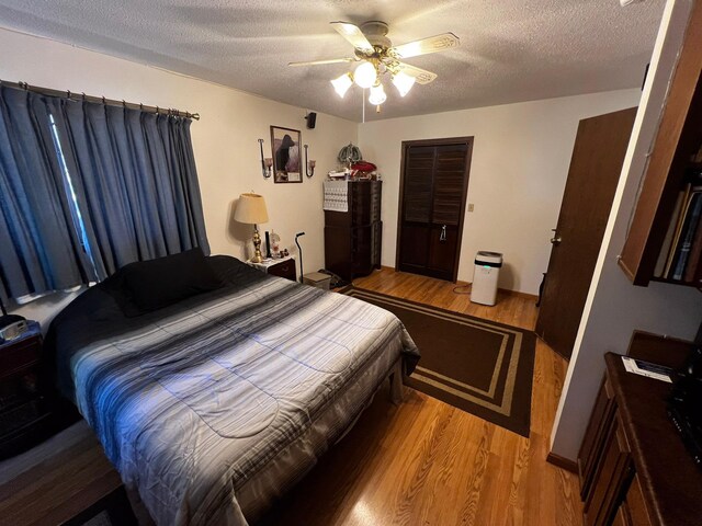 22612 Greenwood Loop, Park Rapids, MN 56470 - bedroom featuring light wood-style flooring, a textured ceiling, and a ceiling fan