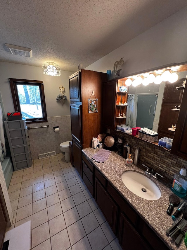 22612 Greenwood Loop, Park Rapids, MN 56470 - full bathroom featuring tile patterned flooring, tile walls, a shower, a wainscoted wall, and vanity