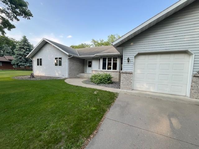 4762 383rd St, Sartell, MN 56377 - ranch-style house with concrete driveway, a front lawn, and a garage