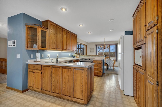 4762 383rd St, Sartell, MN 56377 - kitchen with a peninsula, freestanding refrigerator, light floors, brown cabinets, and recessed lighting