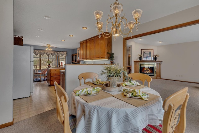 4762 383rd St, Sartell, MN 56377 - dining space with light colored carpet, a chandelier, baseboards, a glass covered fireplace, and recessed lighting