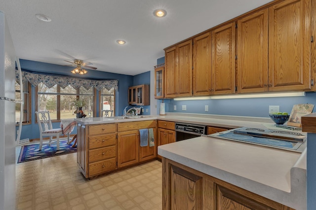 4762 383rd St, Sartell, MN 56377 - kitchen featuring a peninsula, brown cabinets, light floors, a sink, and dishwasher