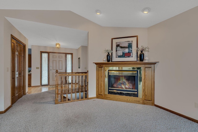 4762 383rd St, Sartell, MN 56377 - carpeted living area featuring baseboards, lofted ceiling, and a glass covered fireplace