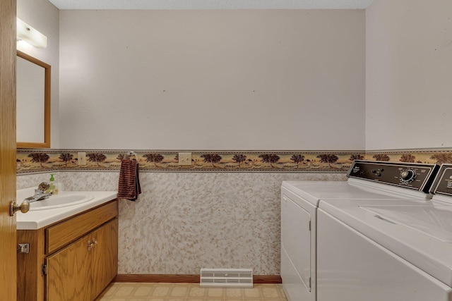 4762 383rd St, Sartell, MN 56377 - bathroom with separate washer and dryer, vanity, tile patterned floors, and wallpapered walls