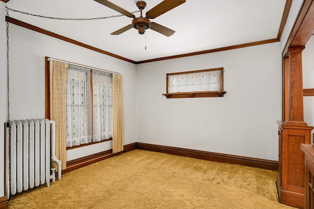 unfurnished room with radiator, light colored carpet, baseboards, a ceiling fan, and ornamental molding