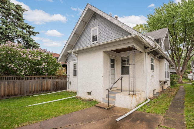 bungalow-style home featuring stucco siding