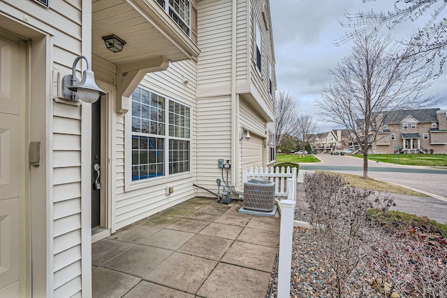 13626 Brass Pkwy Unit 27, Rosemount, MN 55068 - view of patio / terrace with an attached garage, a residential view, and central AC