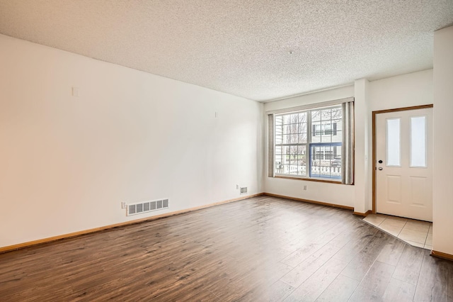 13626 Brass Pkwy Unit 27, Rosemount, MN 55068 - interior space featuring visible vents, baseboards, wood-type flooring, and a textured ceiling