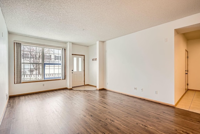 13626 Brass Pkwy Unit 27, Rosemount, MN 55068 - spare room featuring baseboards, hardwood / wood-style flooring, and a textured ceiling