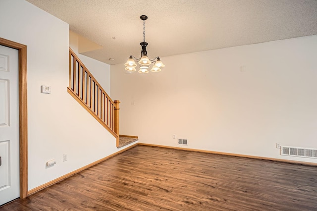 13626 Brass Pkwy Unit 27, Rosemount, MN 55068 - empty room featuring a chandelier, wood finished floors, visible vents, and stairway