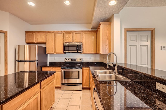 13626 Brass Pkwy Unit 27, Rosemount, MN 55068 - kitchen featuring light tile patterned floors, recessed lighting, dark stone countertops, a sink, and stainless steel appliances