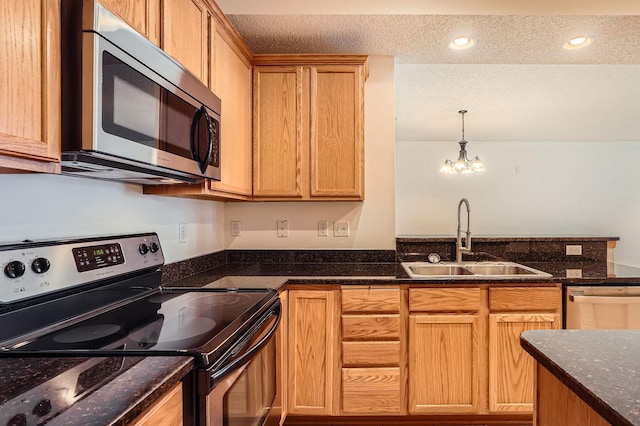13626 Brass Pkwy Unit 27, Rosemount, MN 55068 - kitchen with a chandelier, a textured ceiling, a sink, and appliances with stainless steel finishes