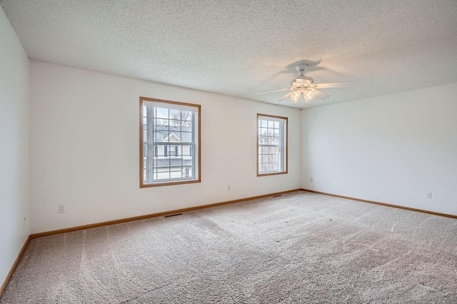 13626 Brass Pkwy Unit 27, Rosemount, MN 55068 - unfurnished room featuring baseboards, a textured ceiling, visible vents, ceiling fan, and carpet