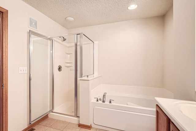 13626 Brass Pkwy Unit 27, Rosemount, MN 55068 - full bathroom with visible vents, a bath, a stall shower, and a textured ceiling