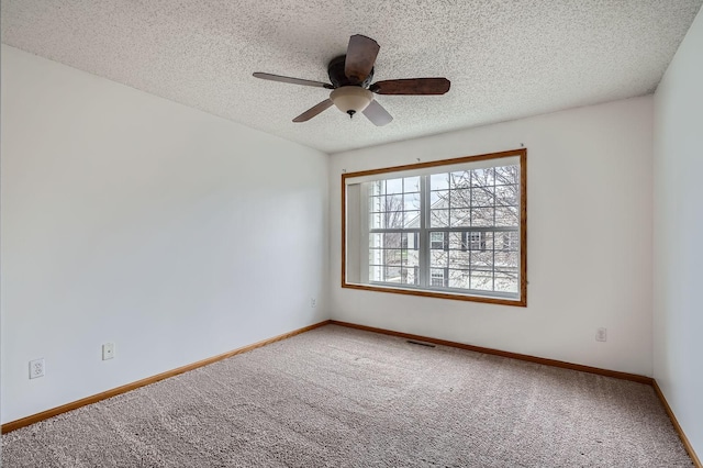 13626 Brass Pkwy Unit 27, Rosemount, MN 55068 - spare room with ceiling fan, a textured ceiling, visible vents, carpet flooring, and baseboards