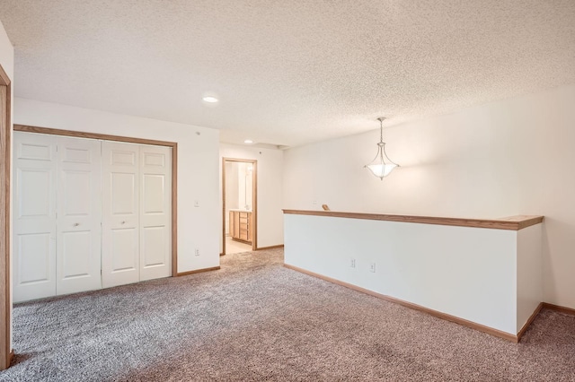 13626 Brass Pkwy Unit 27, Rosemount, MN 55068 - unfurnished living room with a textured ceiling, carpet flooring, baseboards, and recessed lighting
