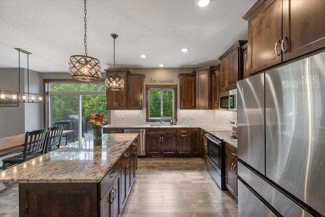1030 Bellaire Blvd NW, Isanti, MN 55040 - kitchen featuring stainless steel appliances, plenty of natural light, wood finished floors, tasteful backsplash, and recessed lighting