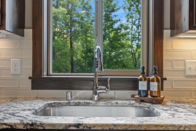 1030 Bellaire Blvd NW, Isanti, MN 55040 - kitchen view of a sink, tasteful backsplash, and light stone counters