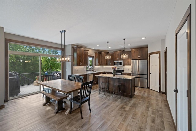 1030 Bellaire Blvd NW, Isanti, MN 55040 - dining area featuring a chandelier, wood finished floors, and recessed lighting