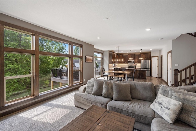1030 Bellaire Blvd NW, Isanti, MN 55040 - living area with recessed lighting, stairs, and dark wood-style flooring
