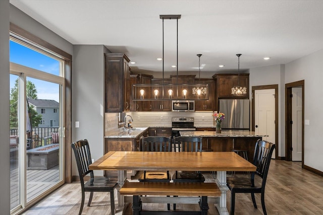 1030 Bellaire Blvd NW, Isanti, MN 55040 - dining space featuring light wood-style flooring, baseboards, and recessed lighting