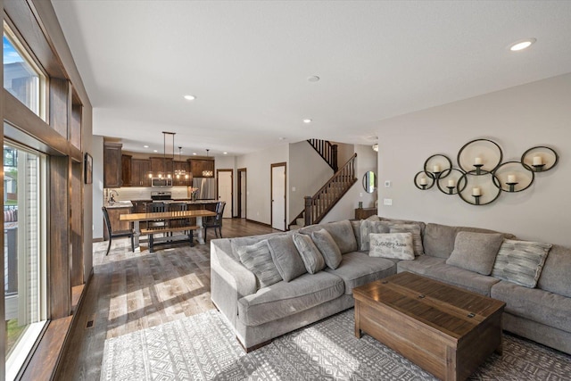1030 Bellaire Blvd NW, Isanti, MN 55040 - living area featuring stairs, wood finished floors, and recessed lighting