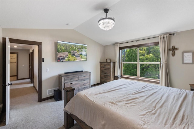 1030 Bellaire Blvd NW, Isanti, MN 55040 - bedroom with vaulted ceiling, light colored carpet, a chandelier, and baseboards