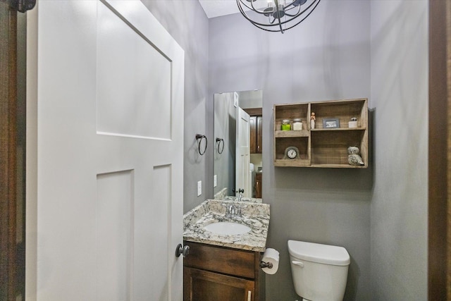 1030 Bellaire Blvd NW, Isanti, MN 55040 - half bathroom featuring toilet, a chandelier, and vanity