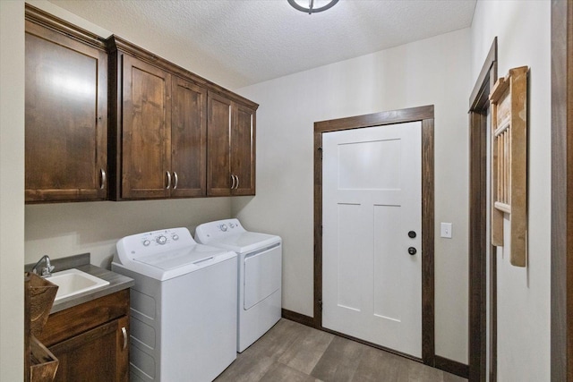 1030 Bellaire Blvd NW, Isanti, MN 55040 - laundry area featuring washer and clothes dryer, cabinet space, wood finished floors, a textured ceiling, and baseboards