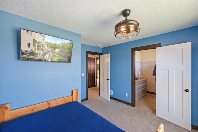 1030 Bellaire Blvd NW, Isanti, MN 55040 - unfurnished bedroom featuring carpet floors, a spacious closet, a textured ceiling, a closet, and baseboards